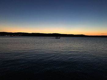 Scenic view of sea against clear sky during sunset