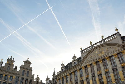 Low angle view of building against cloudy sky