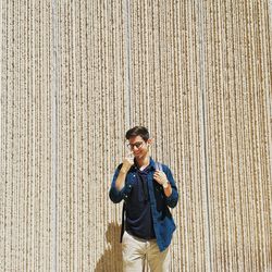 Portrait of a smiling young man standing outdoors