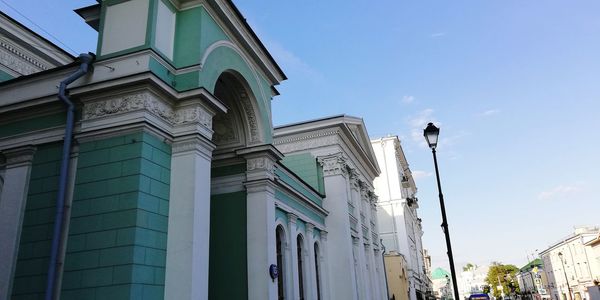 Low angle view of buildings against blue sky