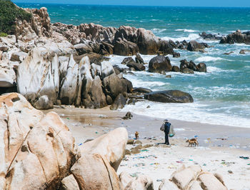 Rocks on beach against sky