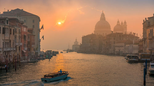 View of buildings in city during sunset