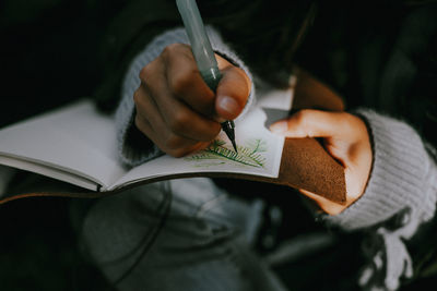 Close-up of hand holding book