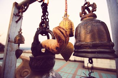 Close-up of metal chain against sky