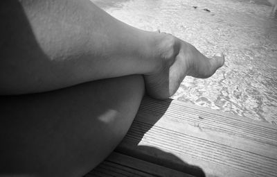 Low section of woman relaxing on beach