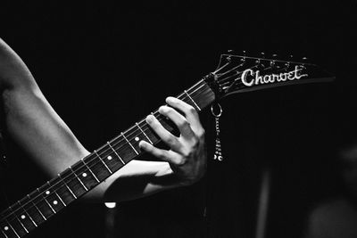 Close-up of man playing guitar