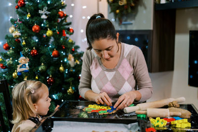 Side view of woman preparing food at home