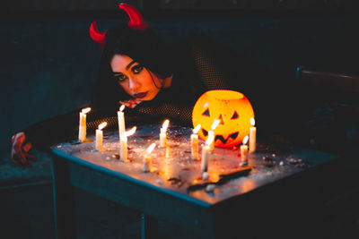 Portrait of woman with burning candles