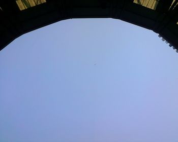 Low angle view of bird against clear blue sky