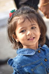 Portrait of cute girl smiling while standing outdoors