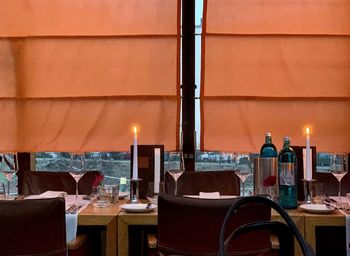 Illuminated candles on dining table in restaurant