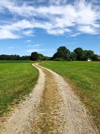 Empty road along countryside landscape