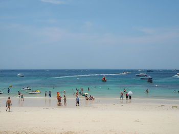 People on beach against sky