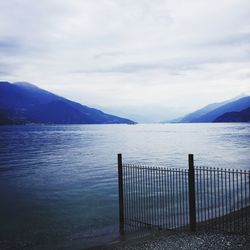 Scenic view of lake against cloudy sky