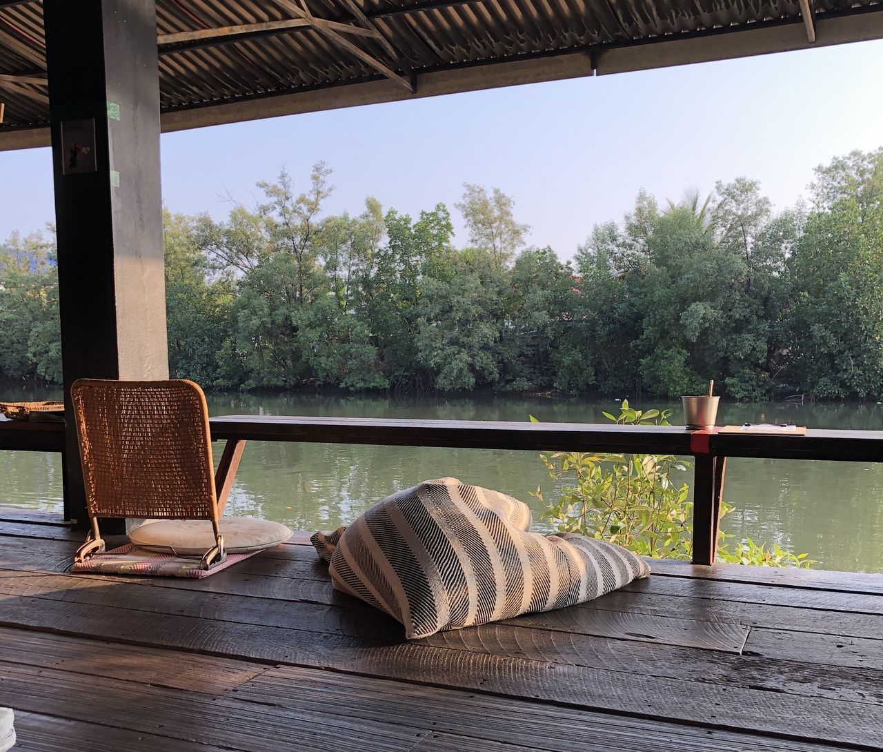 CHAIRS AND TABLE AGAINST TREES