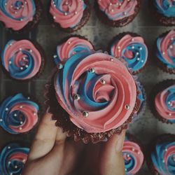 Cropped hand of person holding cupcake