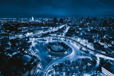 Aerial view of illuminated buildings in city at night