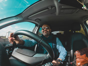 Portrait of man sitting in car