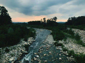 Scenic view of river against sky during sunset