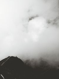 Scenic view of mountains against cloudy sky