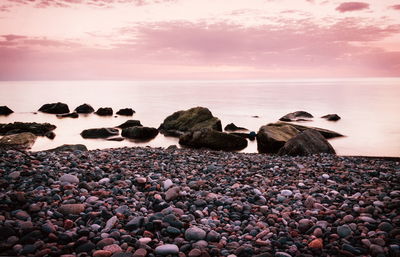 Rocks on beach against sky