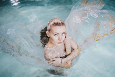 Portrait of young woman in swimming pool