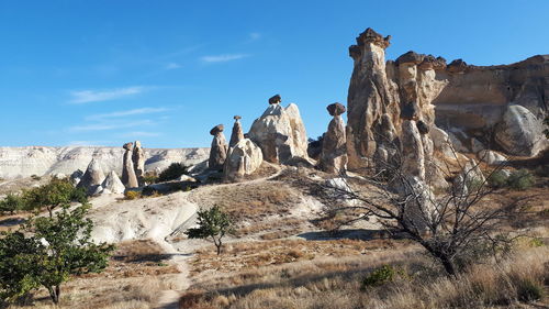 Low angle view of rocks on mountain against sky