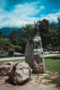 Statue against trees and sky