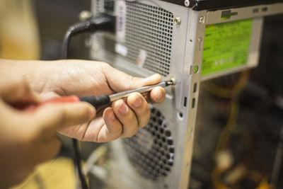 Cropped image of man repairing cpu