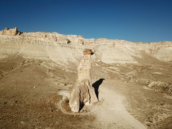 Woman in desert against clear sky