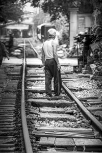 Man standing on railroad tracks