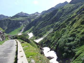 View of narrow stream along mountain range
