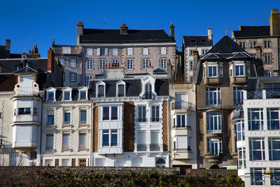 Low angle view of buildings against blue sky