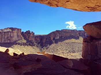 View of rock formations against blue sky