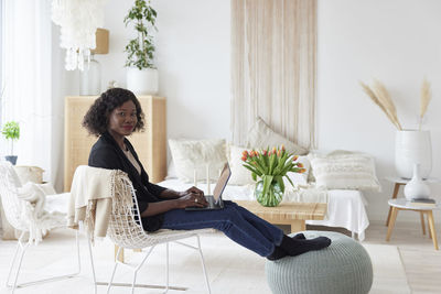 Portrait of woman working on laptop at home