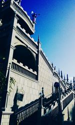 Low angle view of buildings against blue sky