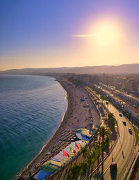 High angle view of road by sea against sky during sunset