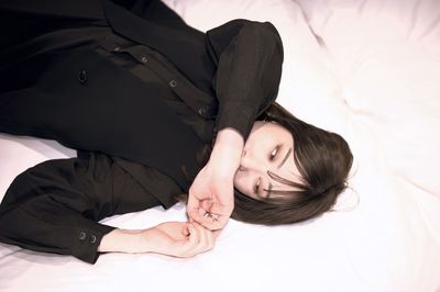 High angle view of woman lying on bed