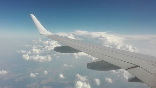 Aerial view of airplane flying in sky