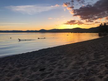 Scenic view of beach against sky during sunset