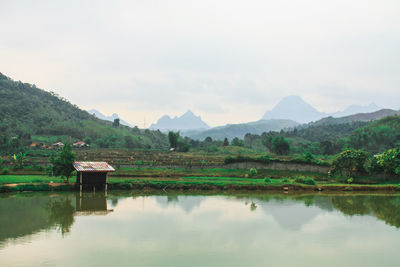 Scenic view of lake and mountains against sky