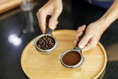 Coffee ground in portafilter for espresso in hand barista