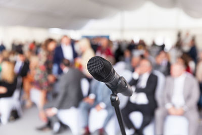 Close-up of microphone against audience