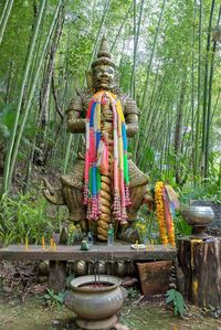 Statue of buddha against trees