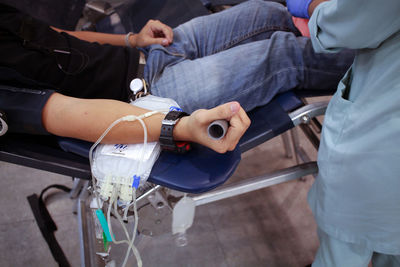 Cropped image of man donating blood in hospital