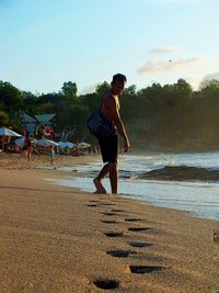 Full length of man with horse against sky