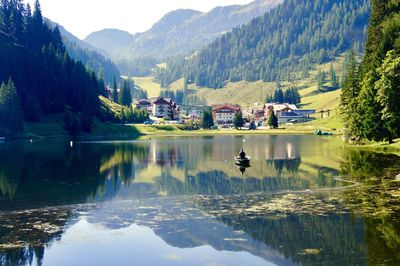 Scenic view of lake by trees and mountains