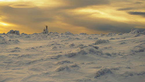 Scenic view of snowcapped mountains against sky during sunset