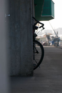 Bicycle in city against sky