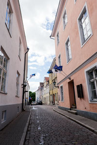 Empty alley amidst buildings in city